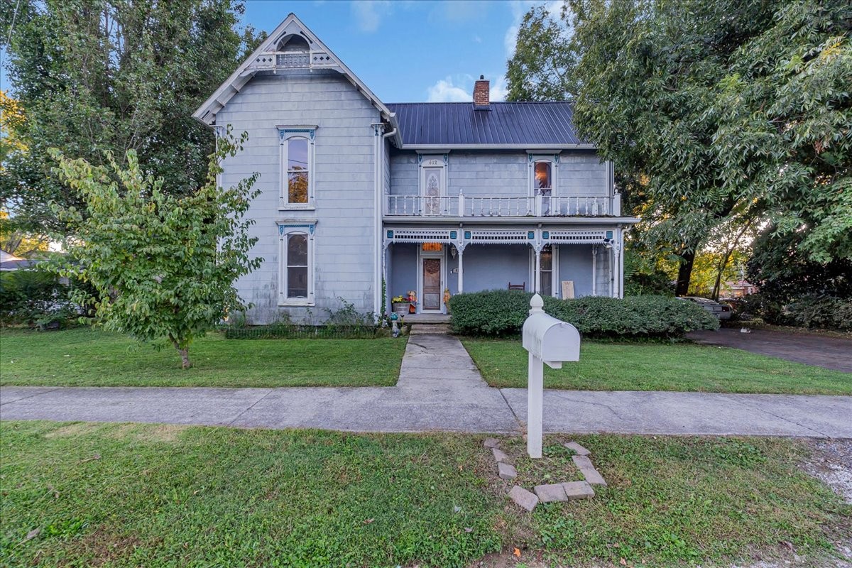 412 East Harp Street Manchester, TN 37355 - Photo 2 of 79 a front view of a house with a yard and trees