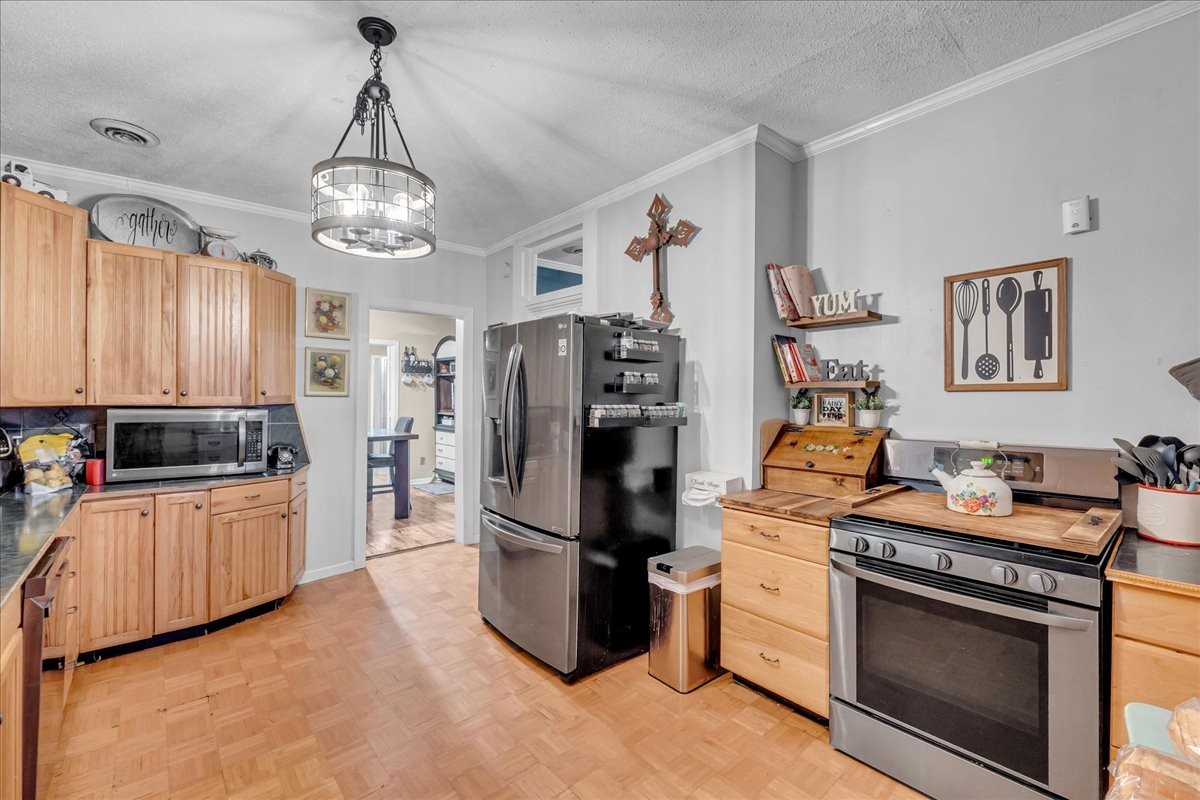 412 East Harp Street Manchester, TN 37355 - Photo 22 of 79 a kitchen with stainless steel appliances granite countertop a refrigerator and a stove top oven