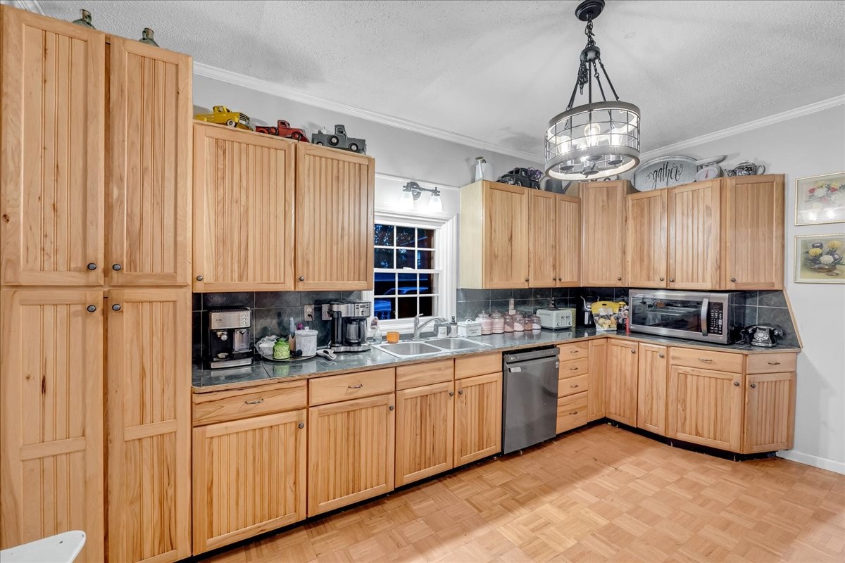 412 East Harp Street Manchester, TN 37355 - Photo 24 of 79 a kitchen with stainless steel appliances a sink a stove a refrigerator cabinets and a window