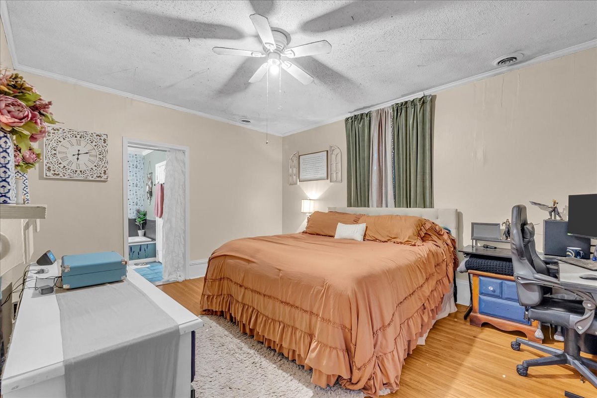 412 East Harp Street Manchester, TN 37355 - Photo 38 of 79 a bedroom with bed and a chandelier