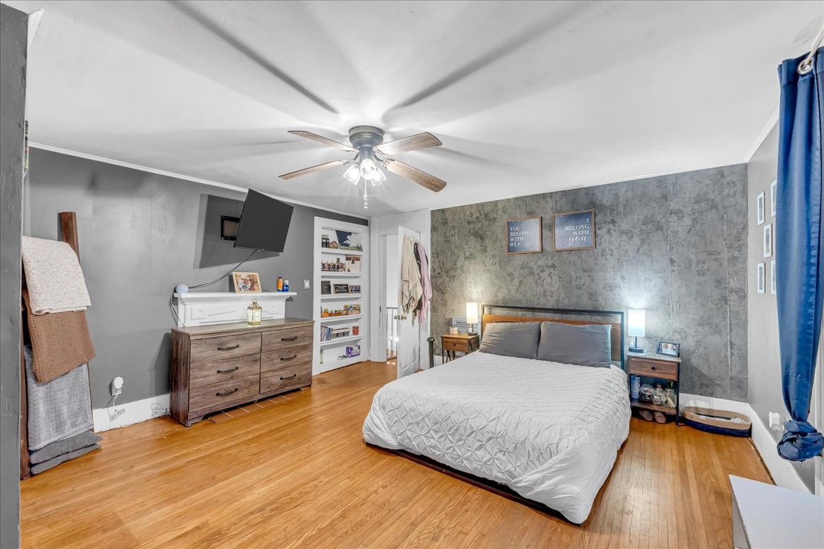 412 East Harp Street Manchester, TN 37355 - Photo 42 of 79 a bedroom with a bed and a chandelier