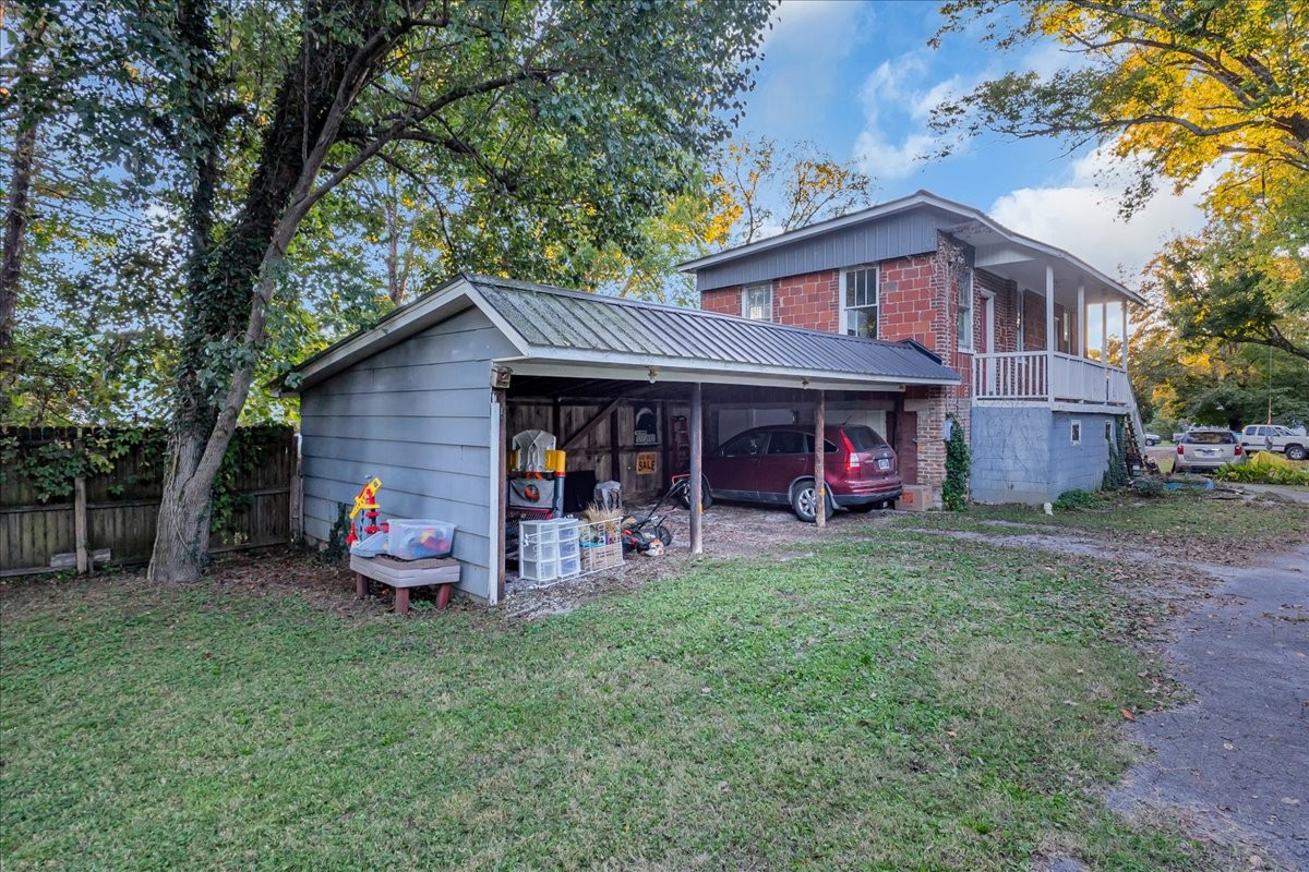 412 East Harp Street Manchester, TN 37355 - Photo 49 of 79 a front view of a house with garden and porch
