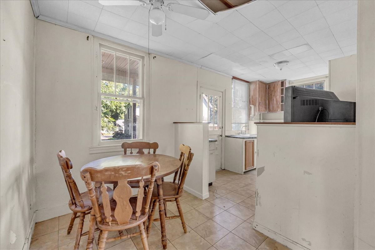 412 East Harp Street Manchester, TN 37355 - Photo 62 of 79 a kitchen with stainless steel appliances a dining table chairs and a refrigerator