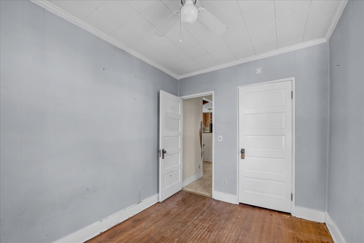 412 East Harp Street Manchester, TN 37355 - Photo 65 of 79 an empty room with wooden floor and ceiling fan