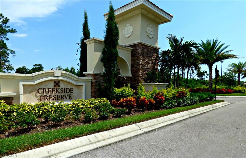 18244 Creekside Preserve Loop, Unit 102 Fort Myers, FL 33908 - Photo 14 of 23 a front view of a house with a yard