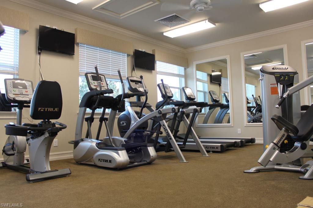 18244 Creekside Preserve Loop, Unit 102 Fort Myers, FL 33908 - Photo 8 of 23 a view of a room with gym equipment