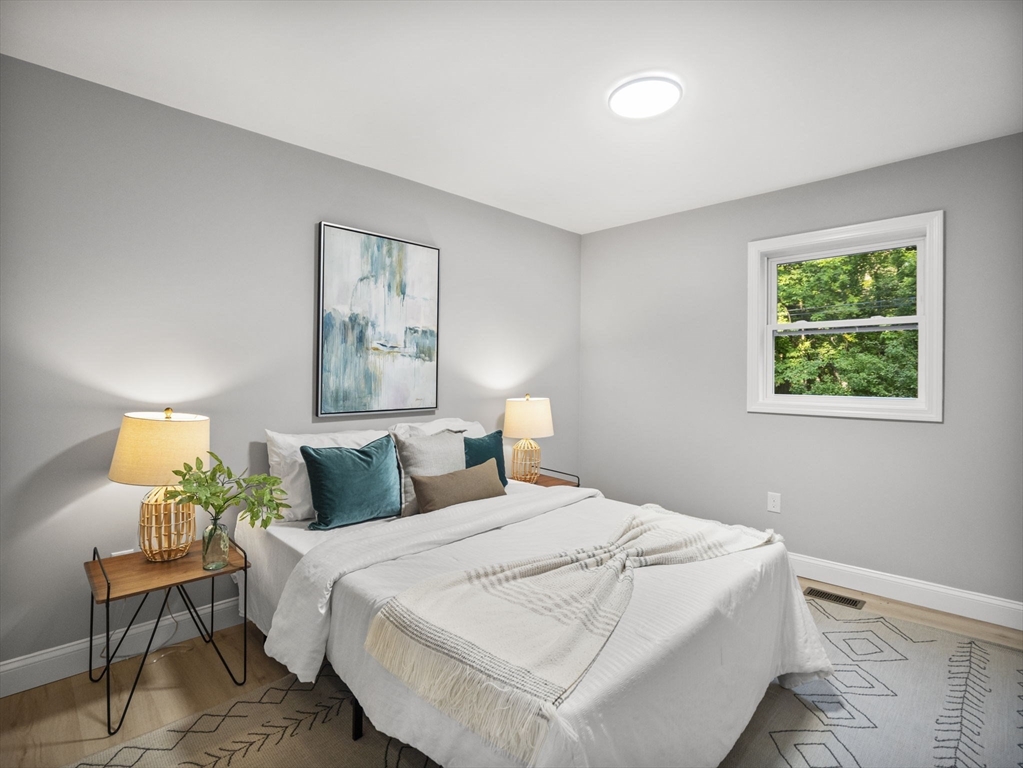 21 Webster Street Andover, MA 01810 - Photo 11 of 24 a bedroom with a bed and a painting on the wall