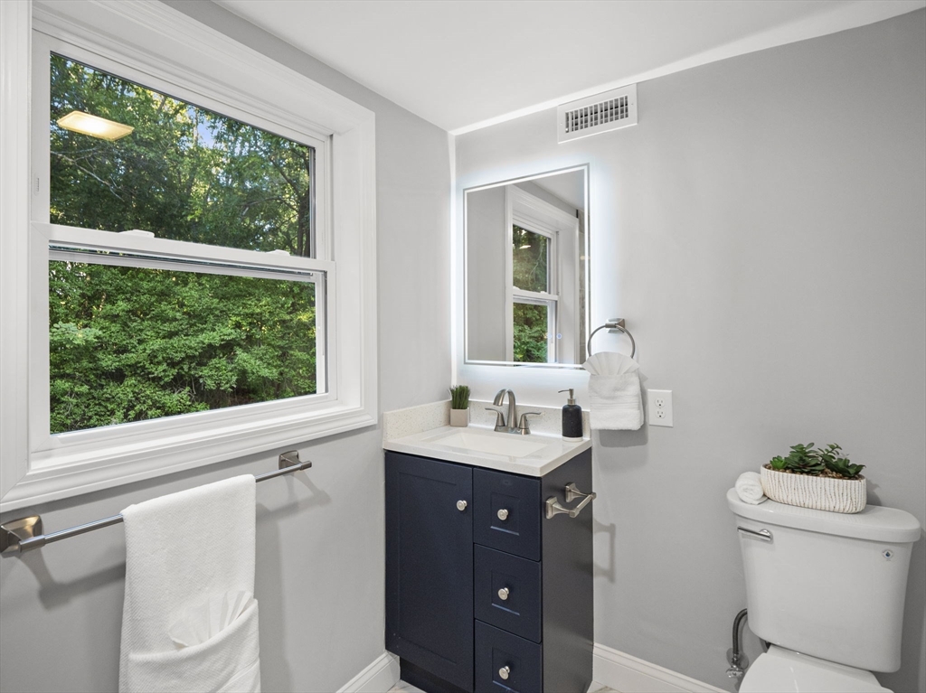 21 Webster Street Andover, MA 01810 - Photo 13 of 24 a bathroom with a double vanity sink toilet and a mirror