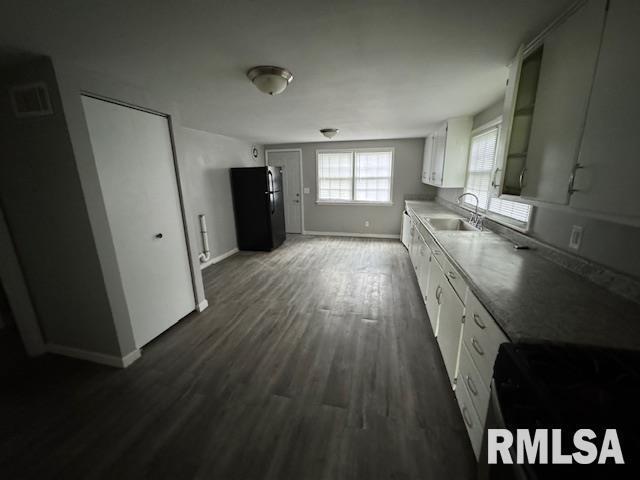 6812 33rd Street Moline, IL 61265 - Photo 5 of 17 a kitchen with granite countertop a refrigerator a sink dishwasher and wooden floor