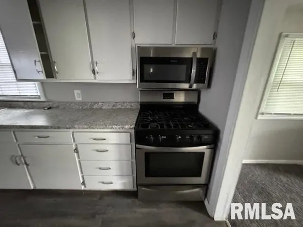 a kitchen with a stove and a microwave
