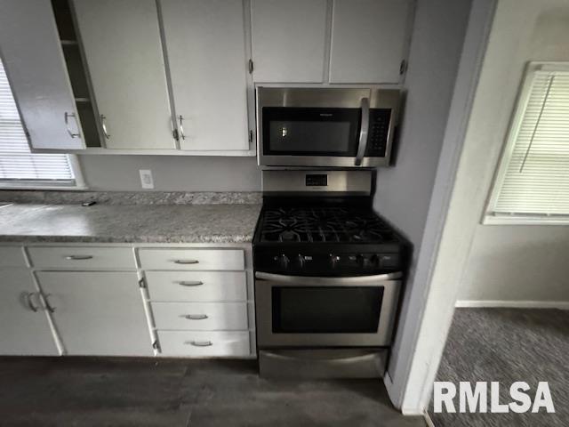 6812 33rd Street Moline, IL 61265 - Photo 10 of 17 a kitchen with a stove and a microwave