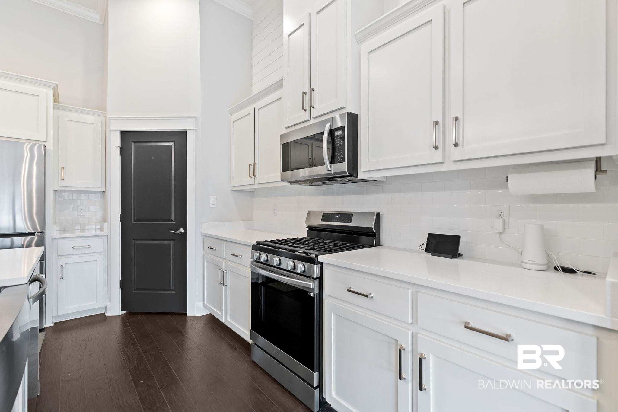 31654 Canopy Loop Daphne, AL 36527 - Photo 19 of 64 Kitchen featuring stainless steel appliances, tasteful backsplash, white cabinetry, and crown molding