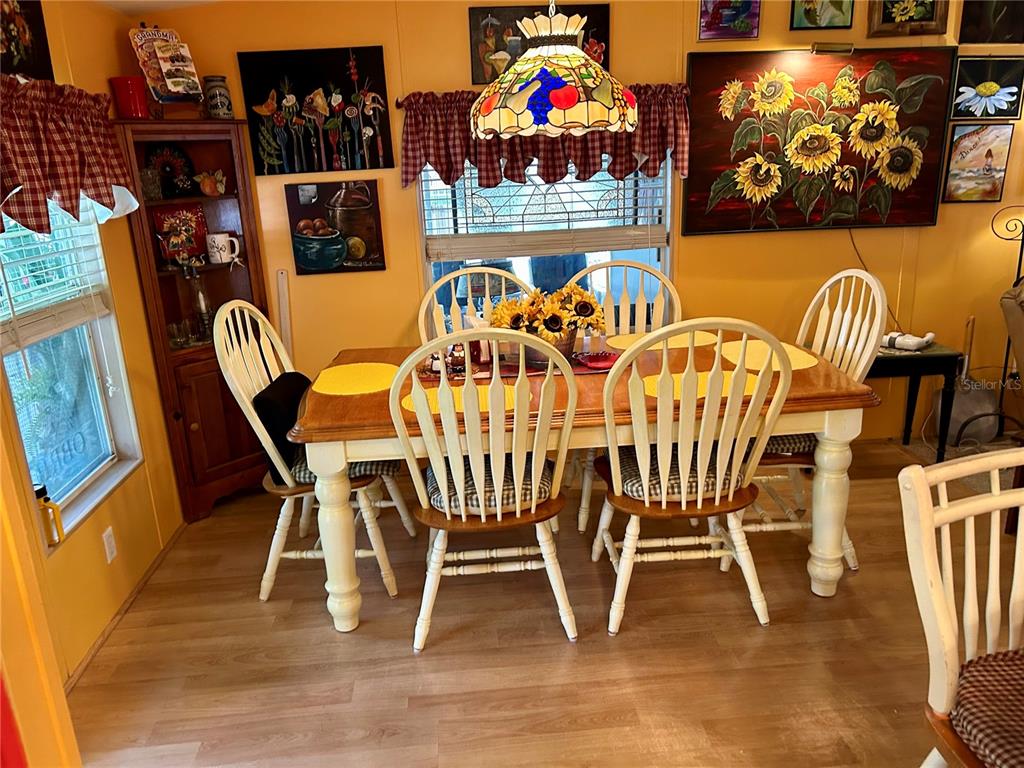 25646 Bass Road Astor, FL 32102 - Photo 27 of 48 a view of a dining room with furniture and wooden floor