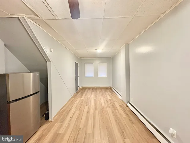 a view of hallway with wooden floor