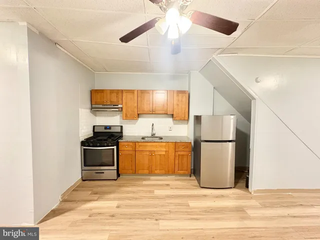 a kitchen with stainless steel appliances a refrigerator and a stove top oven
