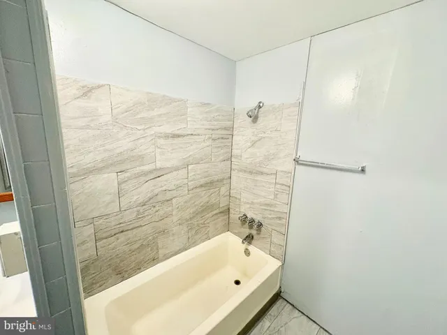 a bathroom with a bathtub and shower