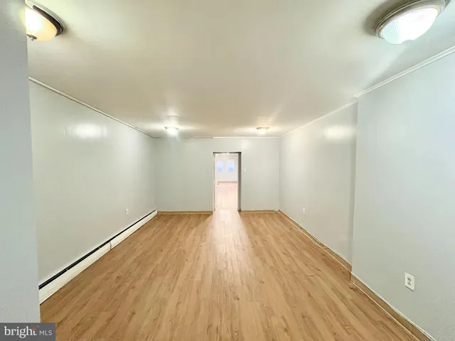 a view of an empty room and wooden floor