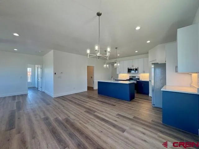 a large kitchen with sink cabinets and stainless steel appliances