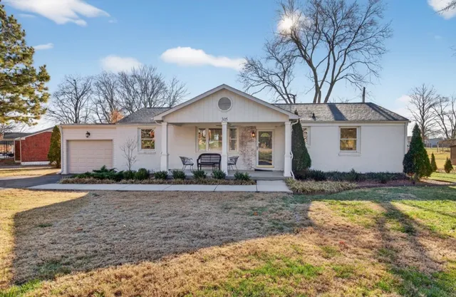 a view of a yard with a house in the background