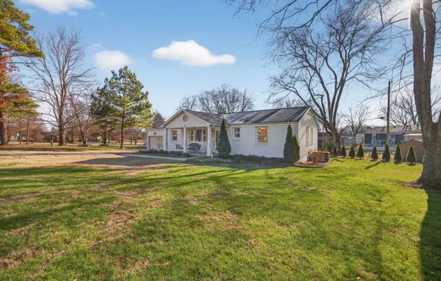 a house view with swimming pool in front of it