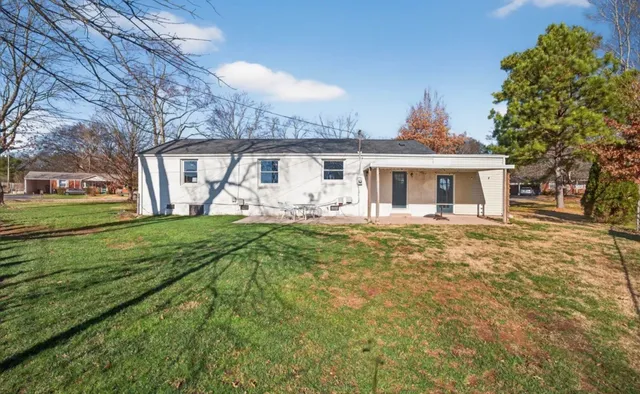 a view of a house with a backyard