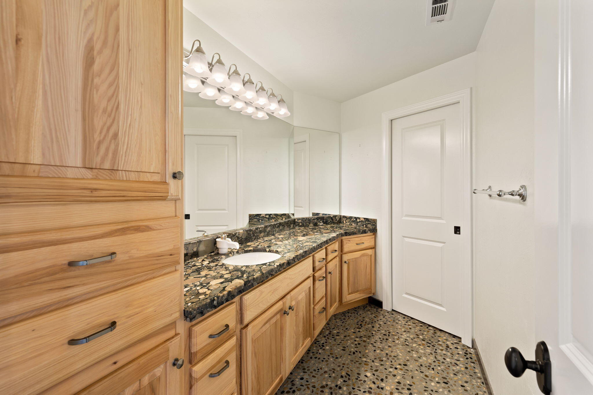 7304 North Applegate Road Grants Pass, OR 97527 - Photo 50 of 87 a spacious bathroom with a granite countertop sink and a mirror