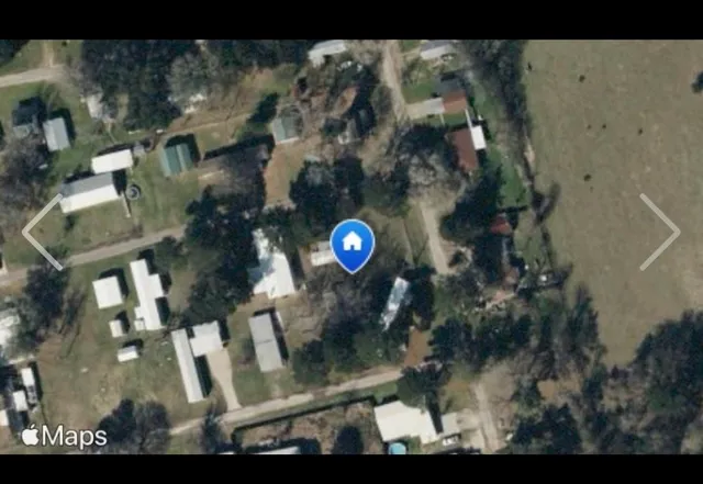 a backyard of a house with lots of green space and plants