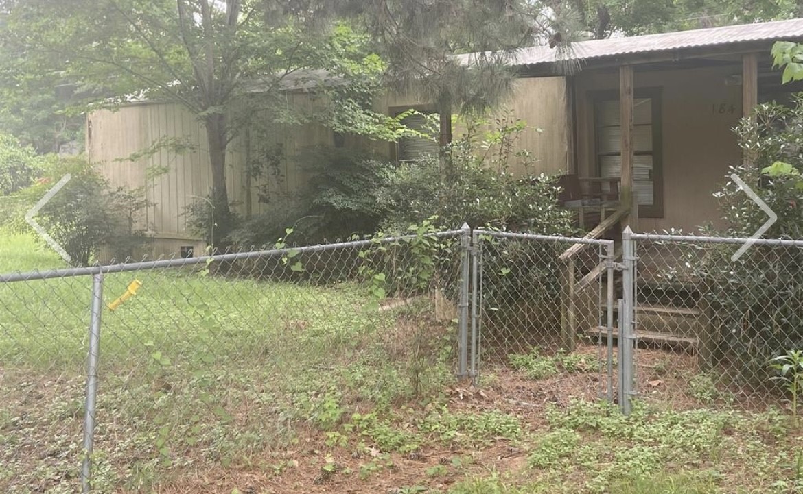 184 Mercury Trinity, TX 75862 - Photo 4 of 16 a backyard of a house with lots of green space and plants