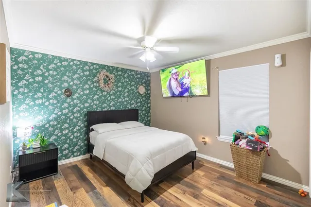 a bedroom with a bed and a potted plant