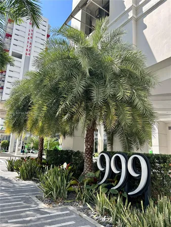 a close up of a sign board with buildings
