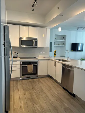 a kitchen with a sink cabinets and stainless steel appliances
