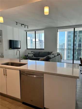a kitchen with a sink and a stove top oven