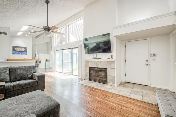 a living room with furniture a flat screen tv and a large window