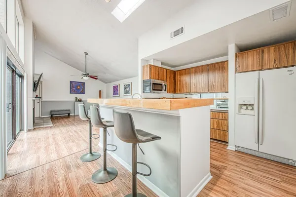 a dining room with furniture wooden floor a rug and a painting