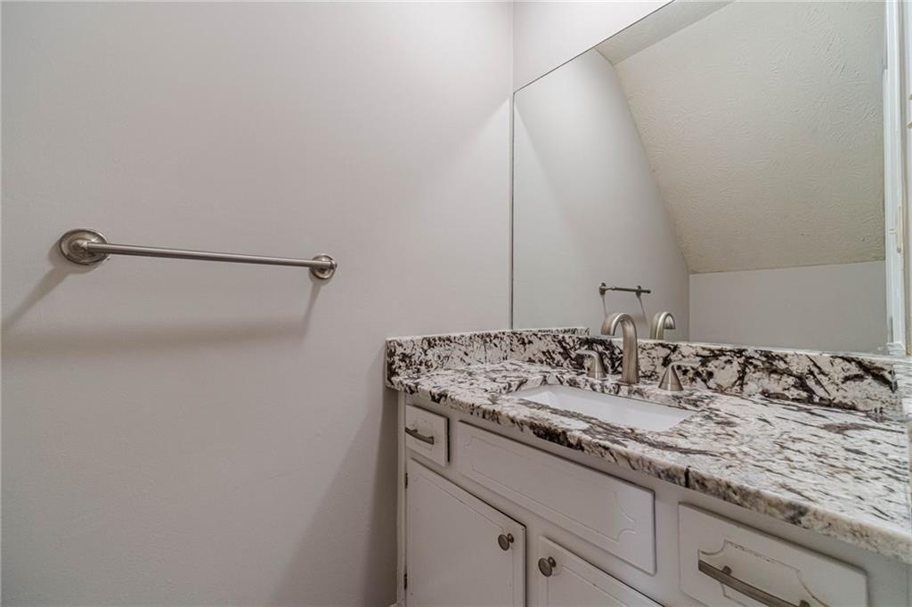 1220 Fieldgate Road Lawrenceville, GA 30044 - Photo 22 of 45 a bathroom with a granite countertop sink and a mirror