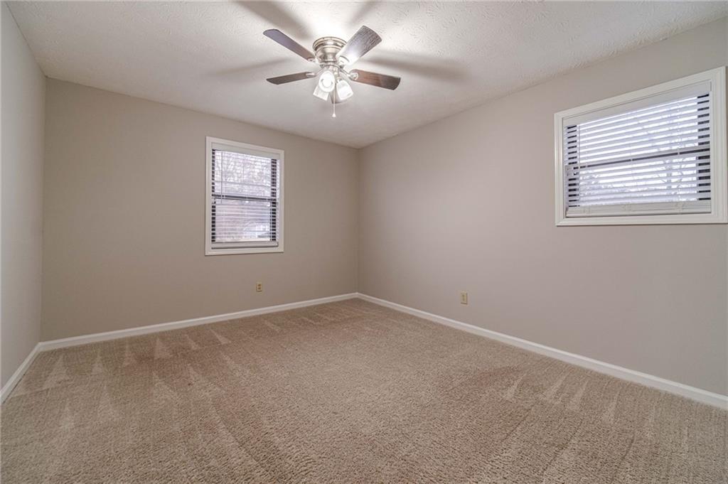 1220 Fieldgate Road Lawrenceville, GA 30044 - Photo 27 of 45 an empty room with windows and fan