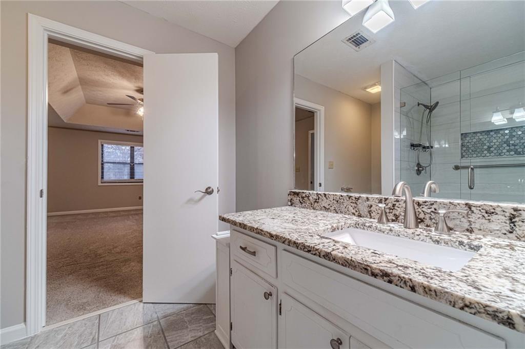 1220 Fieldgate Road Lawrenceville, GA 30044 - Photo 34 of 45 a bathroom with a granite countertop sink and a mirror