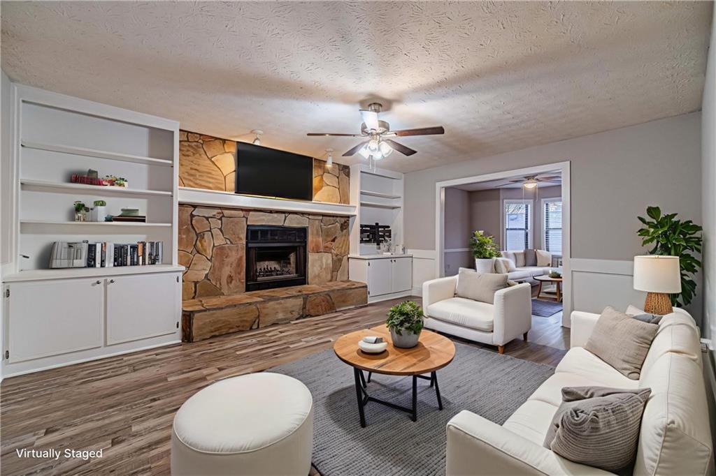 1220 Fieldgate Road Lawrenceville, GA 30044 - Photo 4 of 45 a living room with furniture a flat screen tv and a fireplace