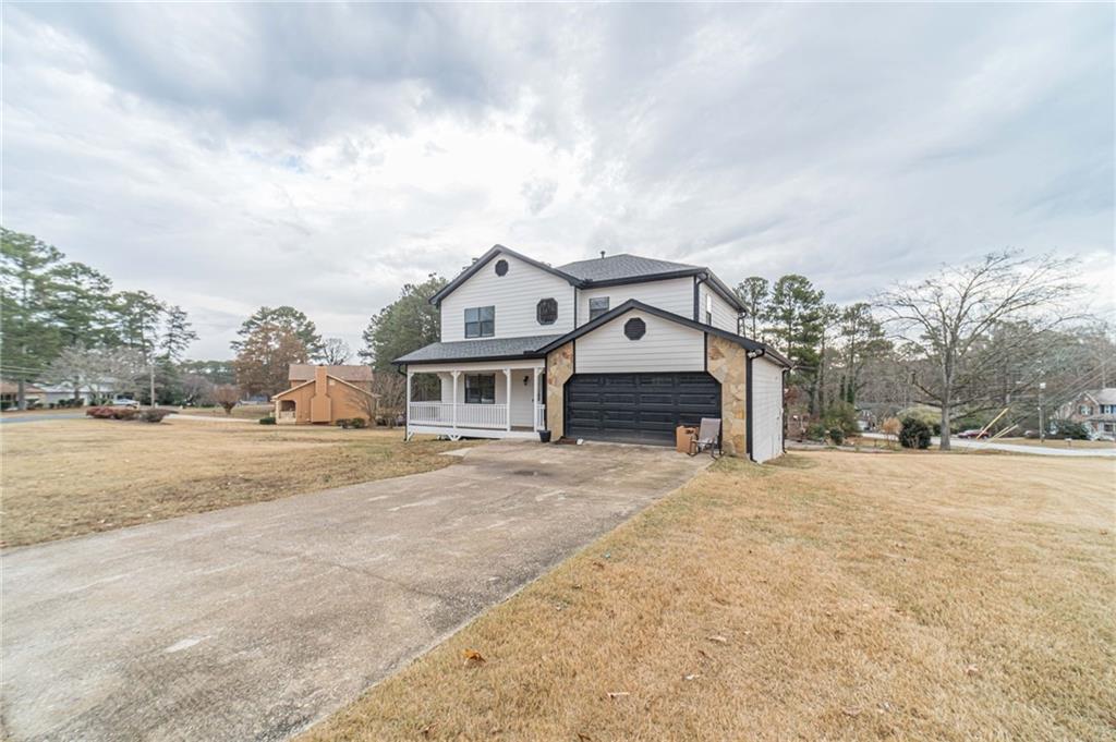 1220 Fieldgate Road Lawrenceville, GA 30044 - Photo 42 of 45 a big house with a big yard and large trees