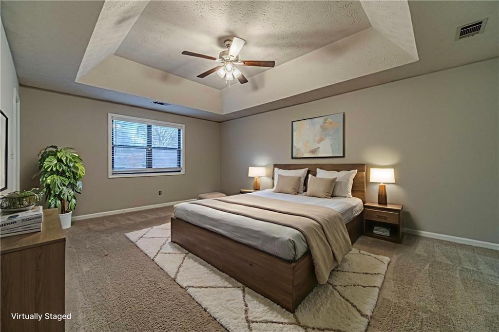 1220 Fieldgate Road Lawrenceville, GA 30044 - Photo 7 of 45 a bedroom with a bed and ceiling fan