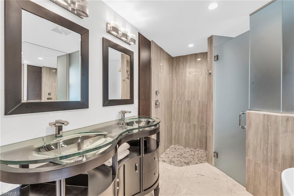 5000 West Boulevard Naples, FL 34103 - Photo 13 of 25 a bathroom with a sink and a mirror