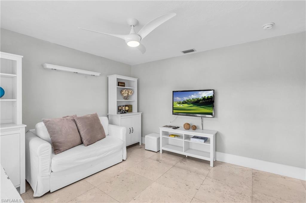 5000 West Boulevard Naples, FL 34103 - Photo 16 of 25 a living room with furniture and a flat screen tv