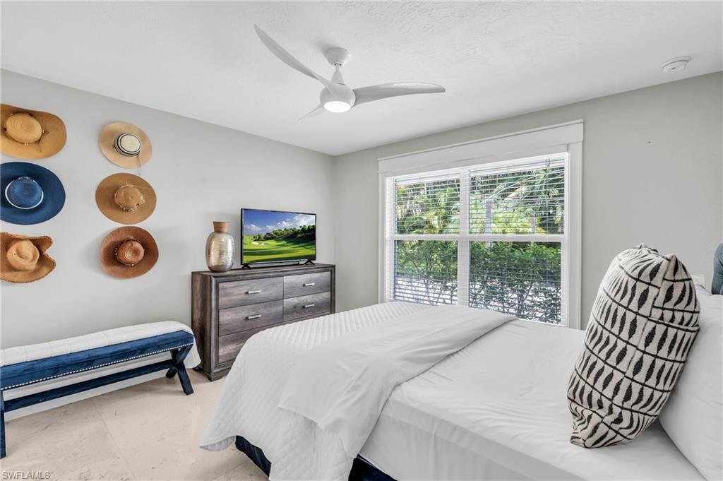 5000 West Boulevard Naples, FL 34103 - Photo 18 of 25 a bedroom with a bed and a window