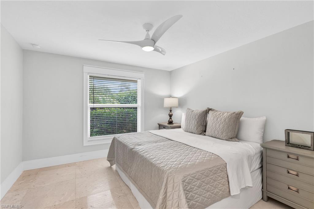 5000 West Boulevard Naples, FL 34103 - Photo 20 of 25 a bedroom with a large bed and a window