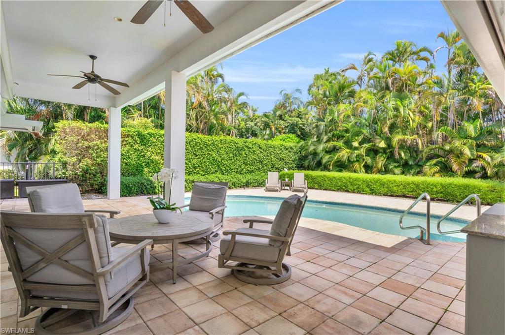 5000 West Boulevard Naples, FL 34103 - Photo 2 of 25 a view of a patio with a table and chairs