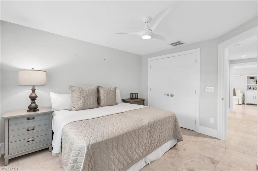 5000 West Boulevard Naples, FL 34103 - Photo 21 of 25 a bedroom with a bed and a lamp