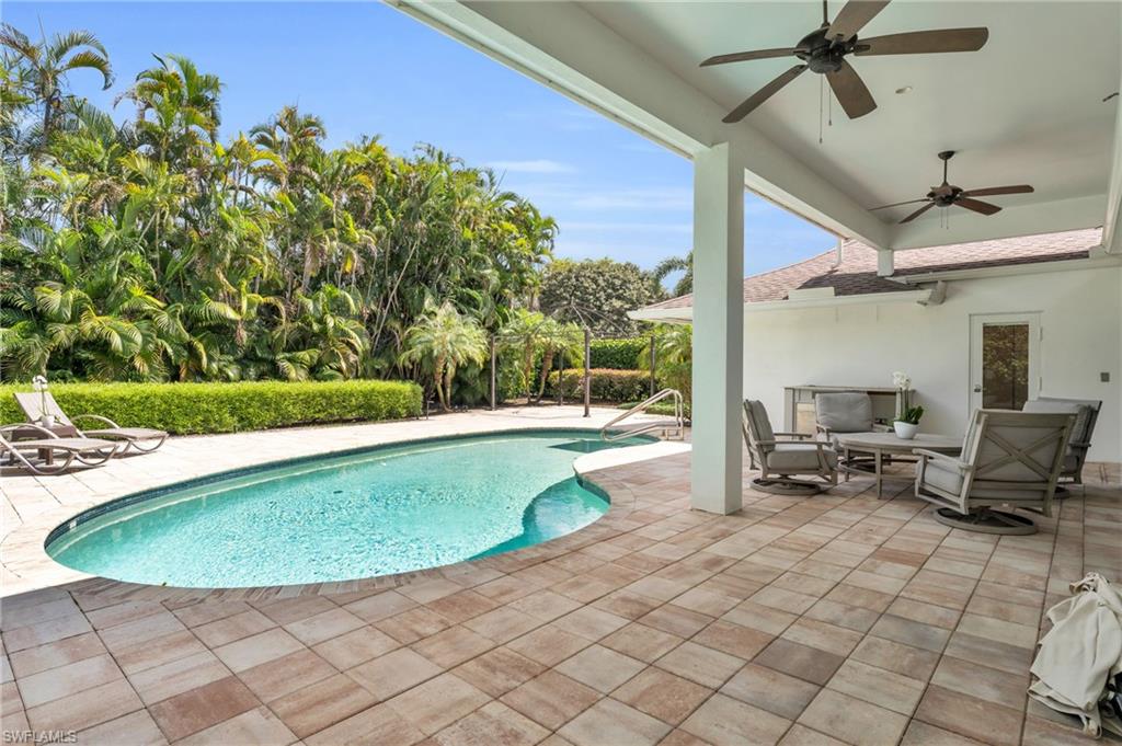 5000 West Boulevard Naples, FL 34103 - Photo 23 of 25 a view of a swimming pool with lounge chair