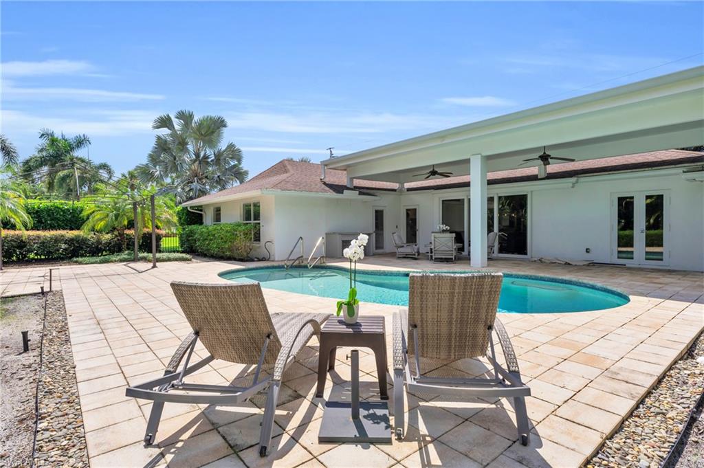 5000 West Boulevard Naples, FL 34103 - Photo 24 of 25 a view of house with seating space and swimming pool
