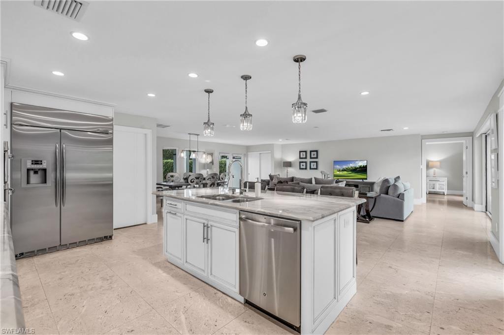 5000 West Boulevard Naples, FL 34103 - Photo 3 of 25 a kitchen with stainless steel appliances granite countertop a sink and cabinets