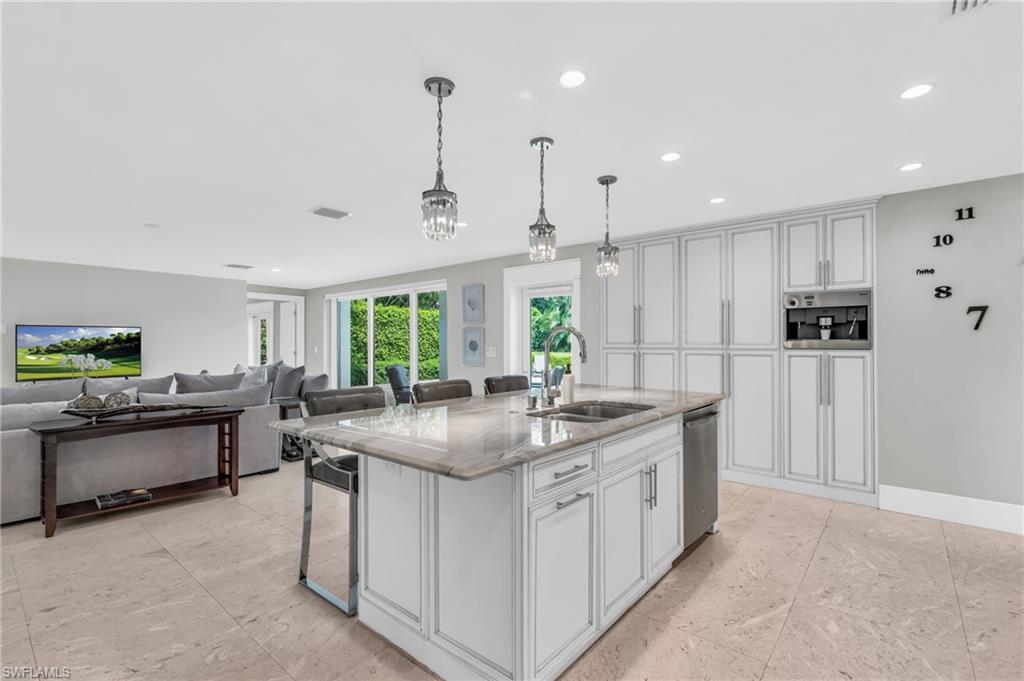 5000 West Boulevard Naples, FL 34103 - Photo 4 of 25 a kitchen with stainless steel appliances granite countertop a sink and a refrigerator